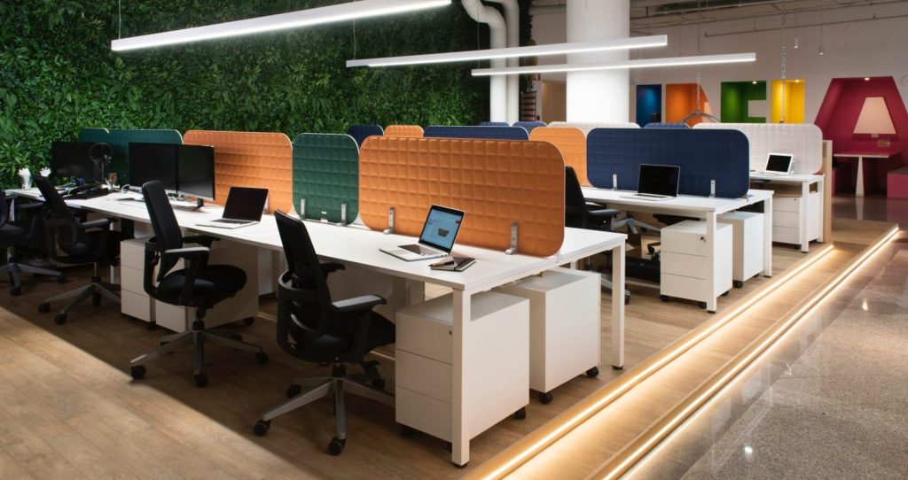 Interno di un ufficio dove è stato fatto trattamento acustico con pannelli fonoassorbenti fra le varie postazioni di lavoro